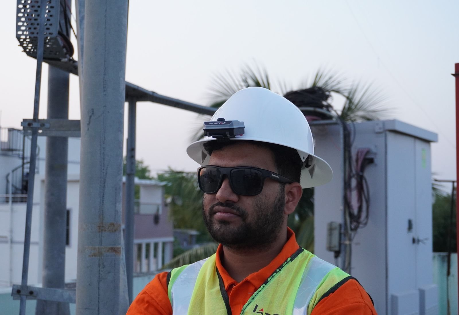 Field technician wearing a SmartVolt voltage detector on his white safety helmet