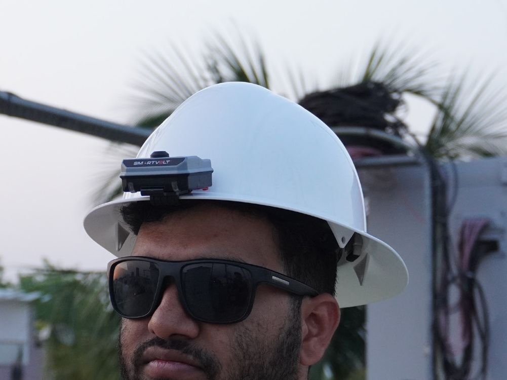 SmartVolt mounted on the front of a white safety helmet