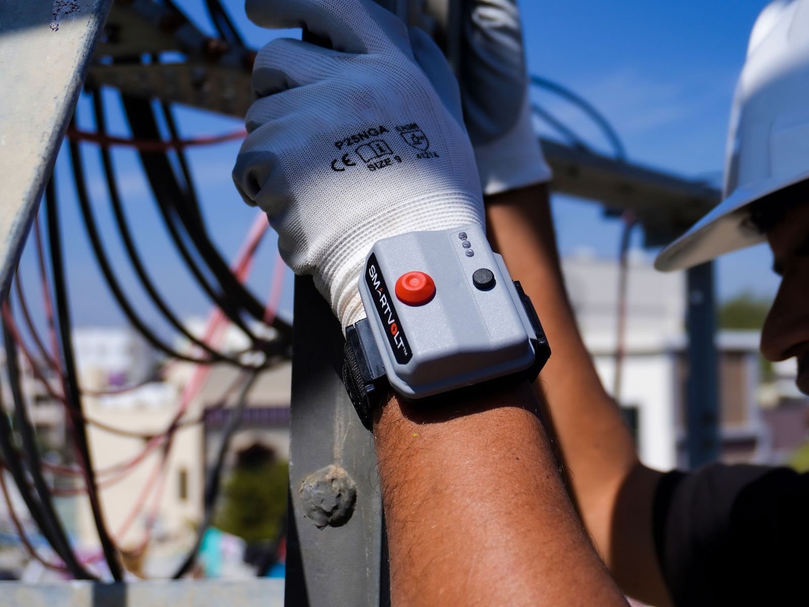 SmartVolt worn on the wrist of a gloved worker