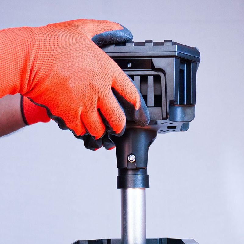 Adjusting the telescopic worklight head with a gloved hand