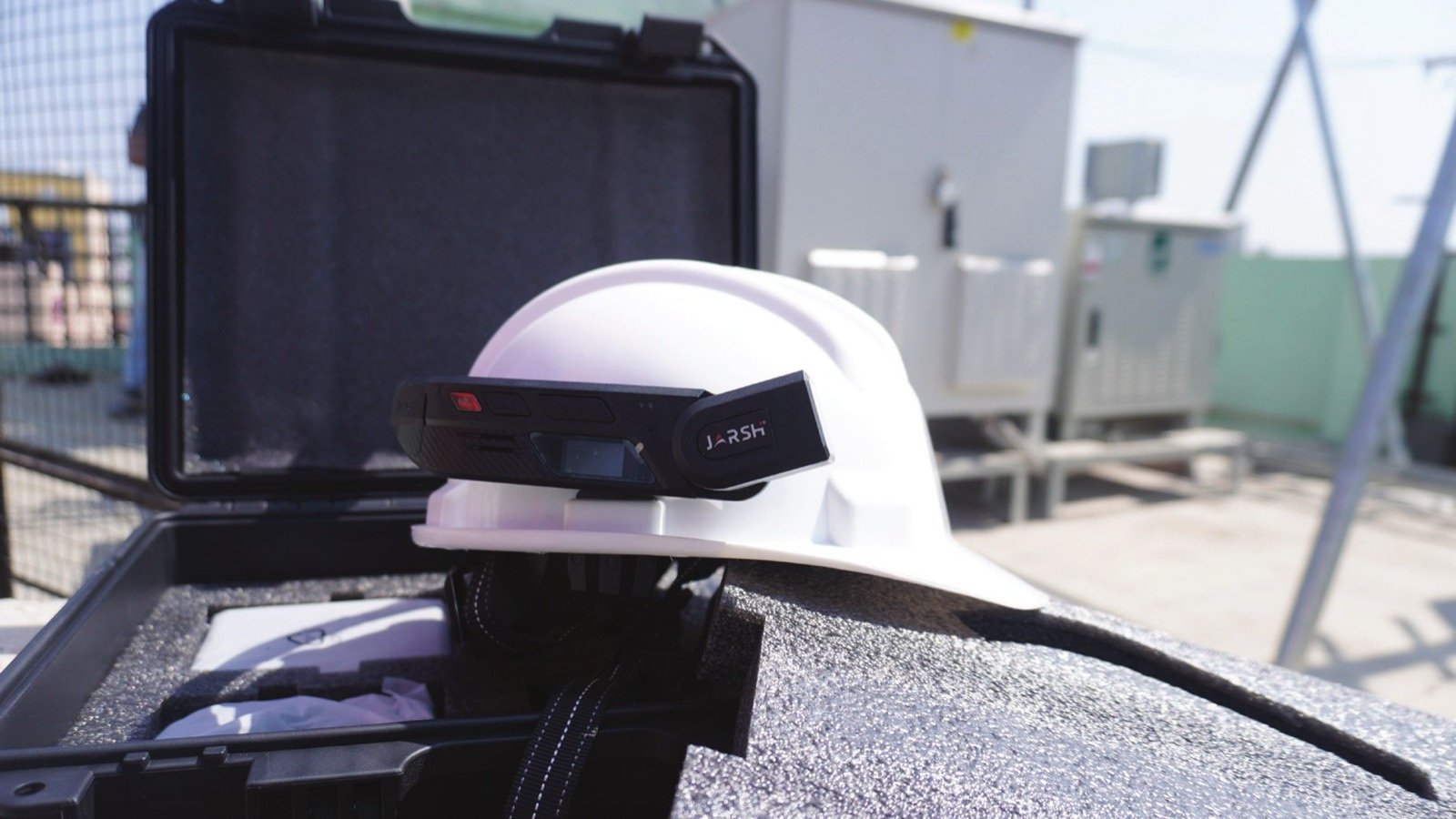 Jarsh WorkAlive camera unit mounted on a white industrial safety helmet at a substation